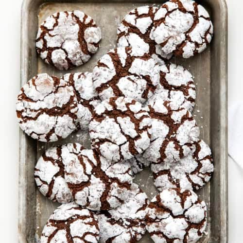 Sheet pan of Chocolate Peppermint Crinkle Cookies on a white table from overhead.