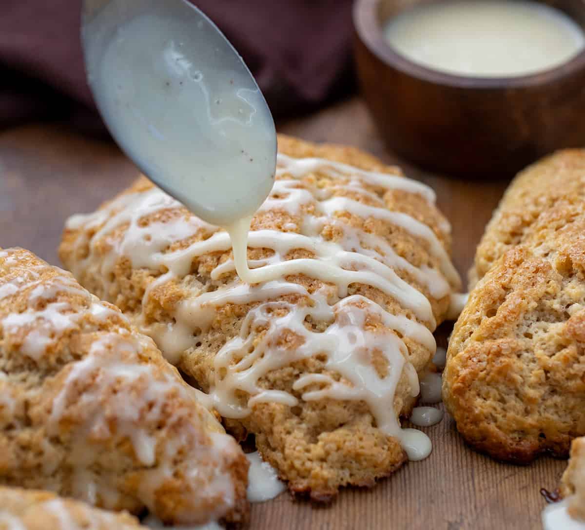 Drizzling glaze over eggnog scones.