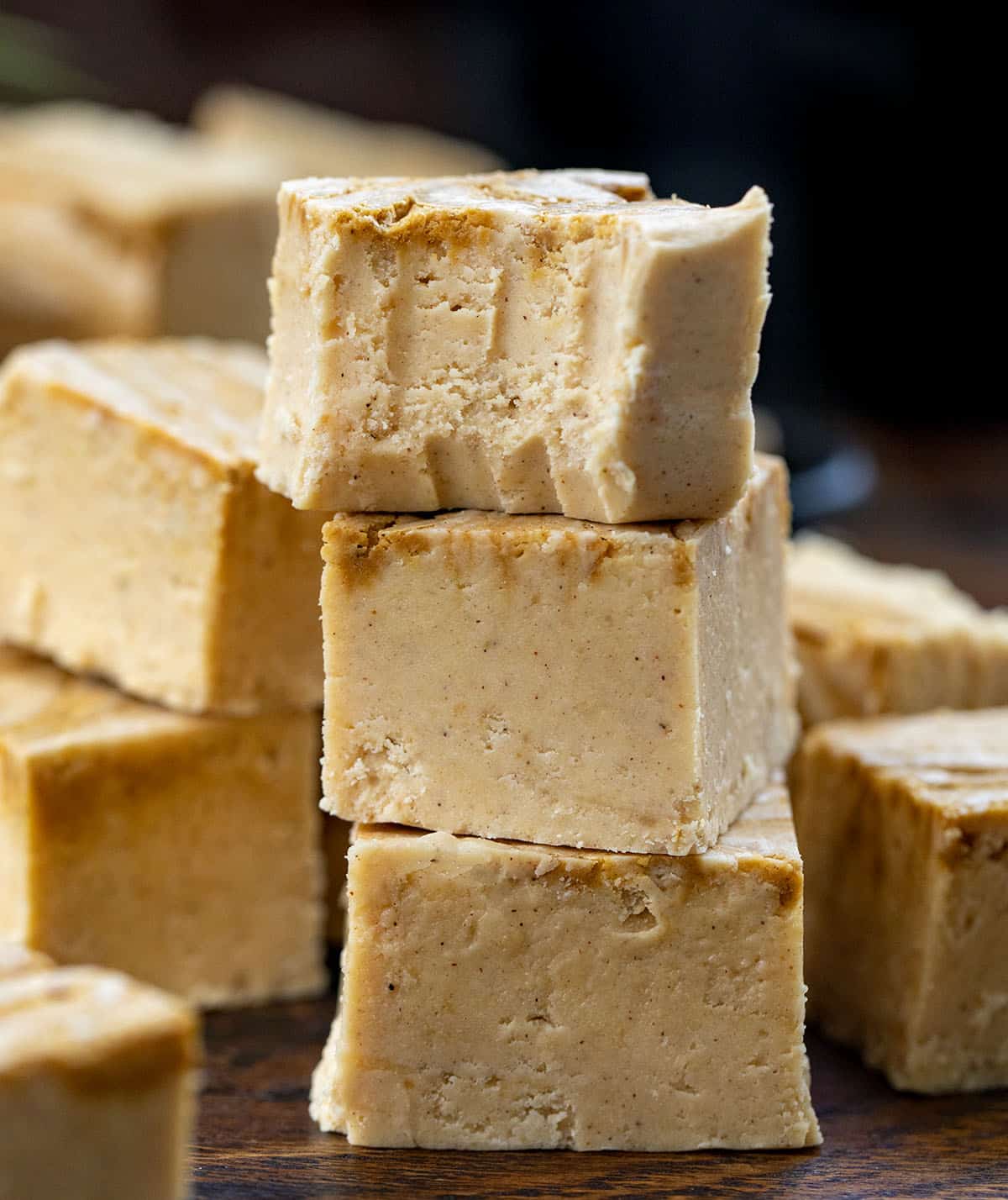 Stack of Gingerbread Fudge with the top piece having a bite taken out of it.