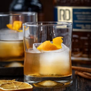 Close up of a glass of Maple Old Fashioned with an orange twist.