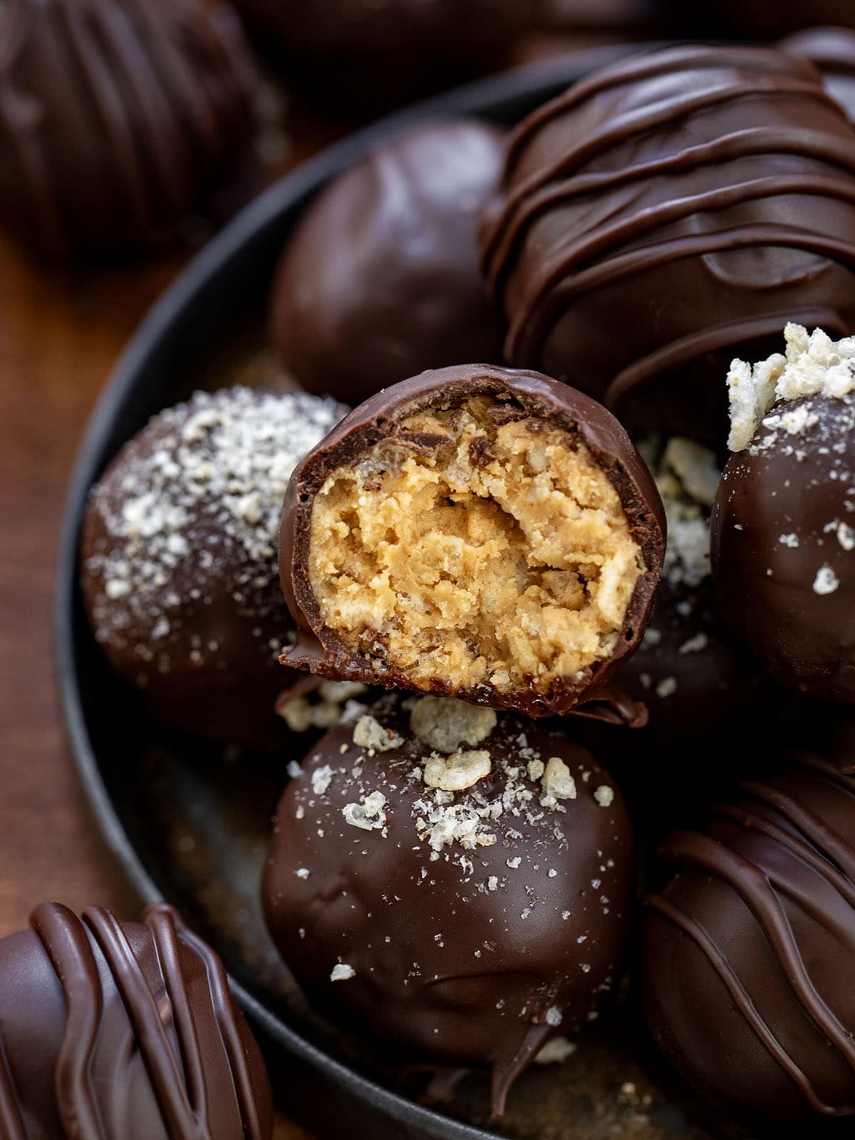 These Peanut Butter Balls with Rice Krispies are sweet, crunchy, and totally irresistible! Creamy peanut butter meets crispy cereal and a rich chocolate coating, making them the perfect treat!