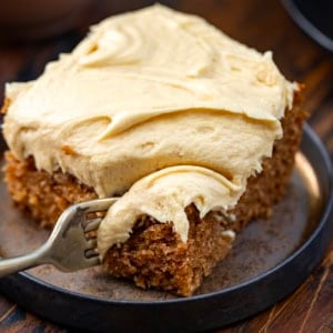Fork taking a bite of Sour Cream Spice Cake.