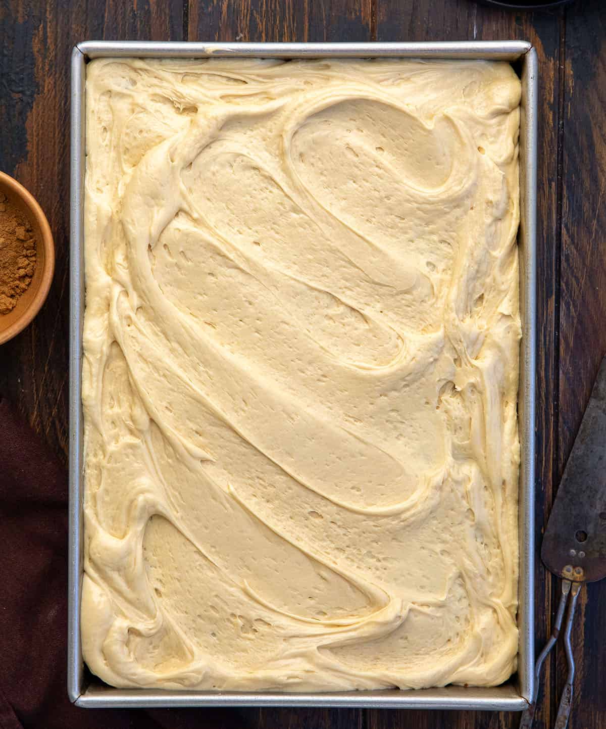 Whole Sour Cream Spice Cake on a wooden table from overhead.