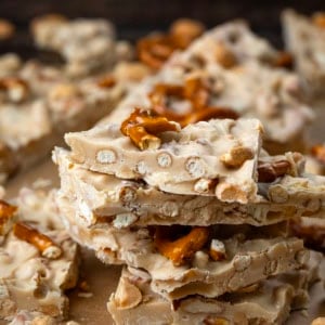 Small stack of broken White Chocolate Peanut Butter Pretzel Bark pieces.