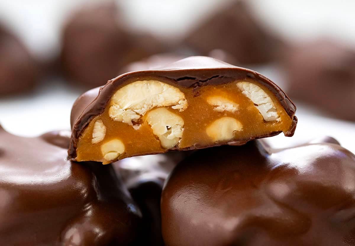 Close up of Chocolate Caramel Cashew Cluster cut in half showing inside.