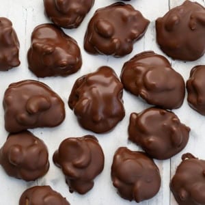 Chocolate Caramel Cashew Clusters on a white table from overhead.