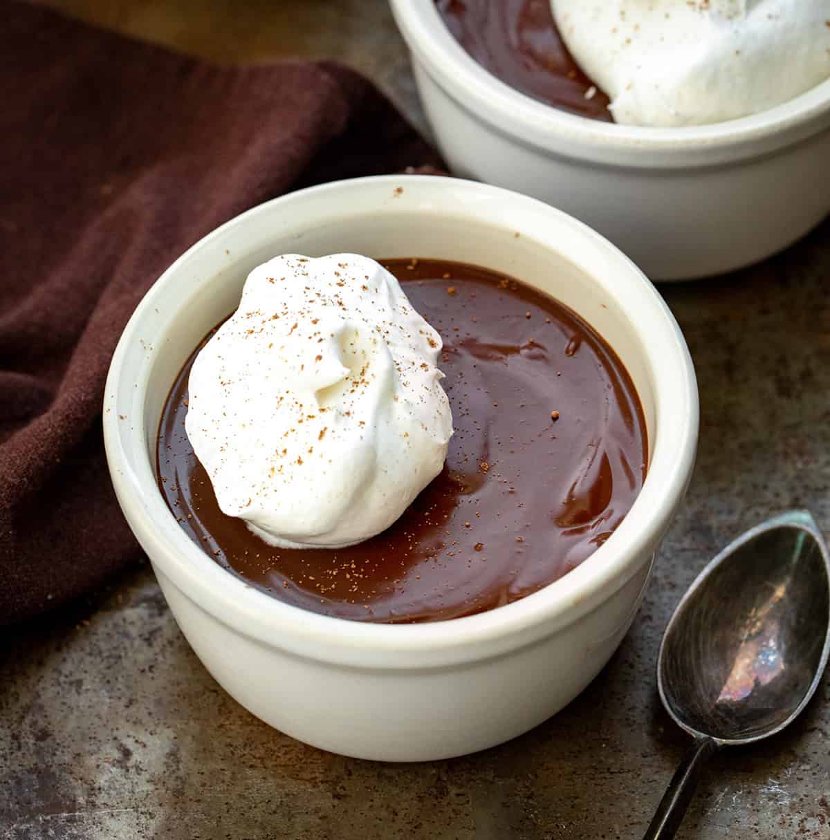 Close up of white Chocolate Pots De Crème with a spoon.