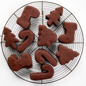 Chocolate Sugar Cookies on a round cooling rack on a white table from overhead.