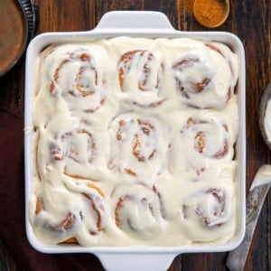 Eggnog Cinnamon Rolls on a wooden table from overhead.
