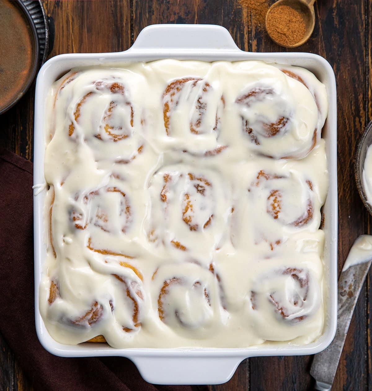 Eggnog Cinnamon Rolls on a wooden table from overhead.