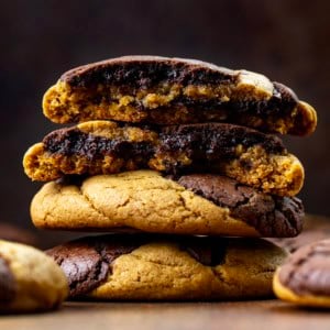 Stack of Ginger Brownie Cookies with the top cookie halved showing the inside texture.