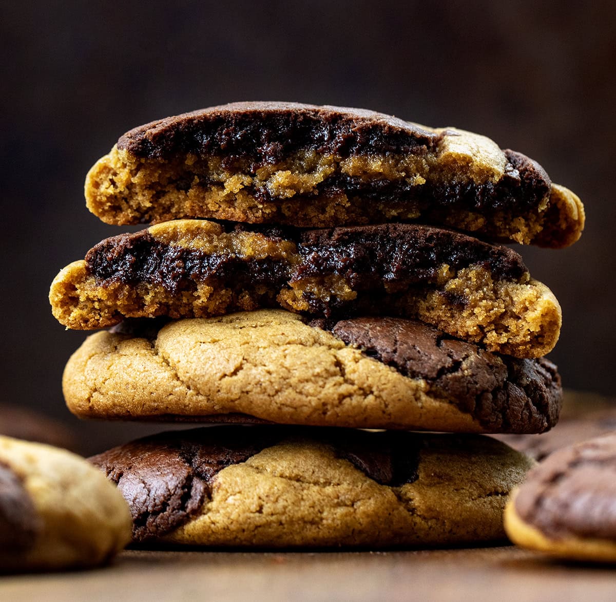 Stack of Ginger Brownie Cookies with the top cookie halved showing the inside texture.