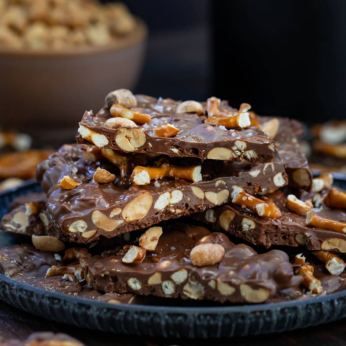 Stack of Milk Chocolate Peanut Butter Pretzel Bark on a platter.