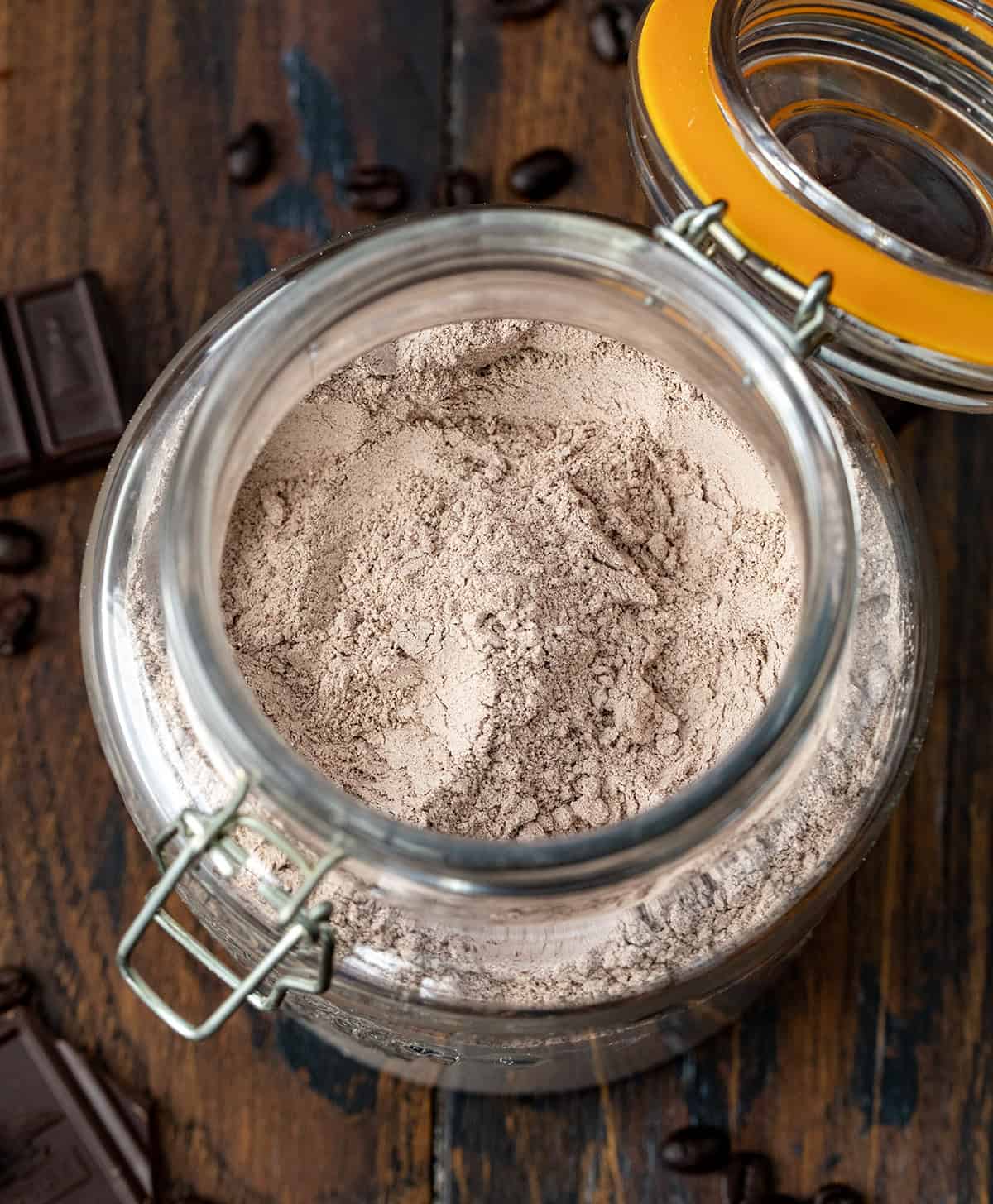 Warm up your mornings with this Mocha Hot Cocoa Mix! Rich cocoa, a hint of espresso, and sweet powdered milk come together to create a creamy, chocolatey mug of comfort in minutes! Looking down into a jar of Mocha Hot Cocoa Mix.