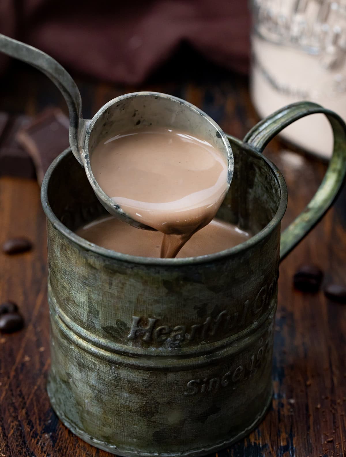 Warm up your mornings with this Mocha Hot Cocoa Mix! Rich cocoa, a hint of espresso, and sweet powdered milk come together to create a creamy, chocolatey mug of comfort in minutes! Pouring Mocha Hot Cocoa Mix into a mug with a ladle.