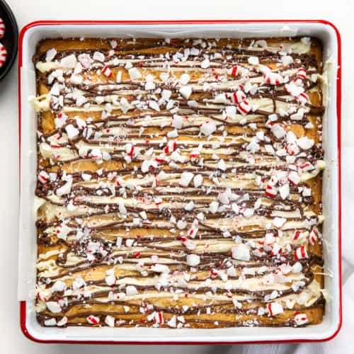 Pan of Peppermint Bark Blondies on a white table from overhead.