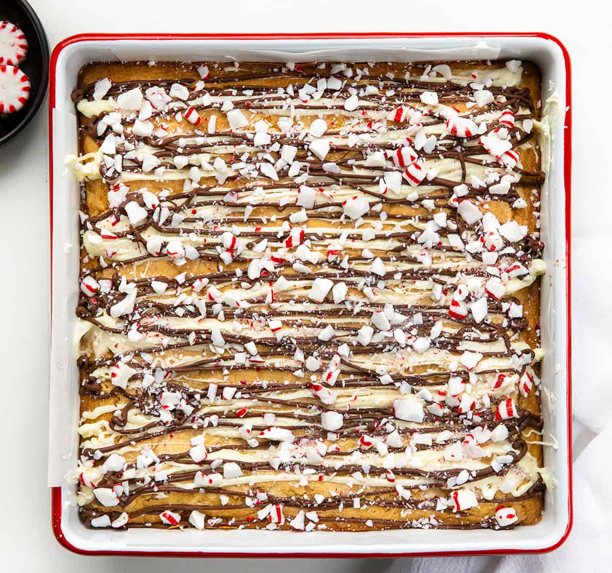 Pan of Peppermint Bark Blondies on a white table from overhead.