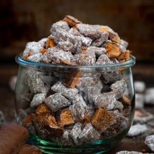 Jar of Butterfinger Puppy Chow on a dark table.