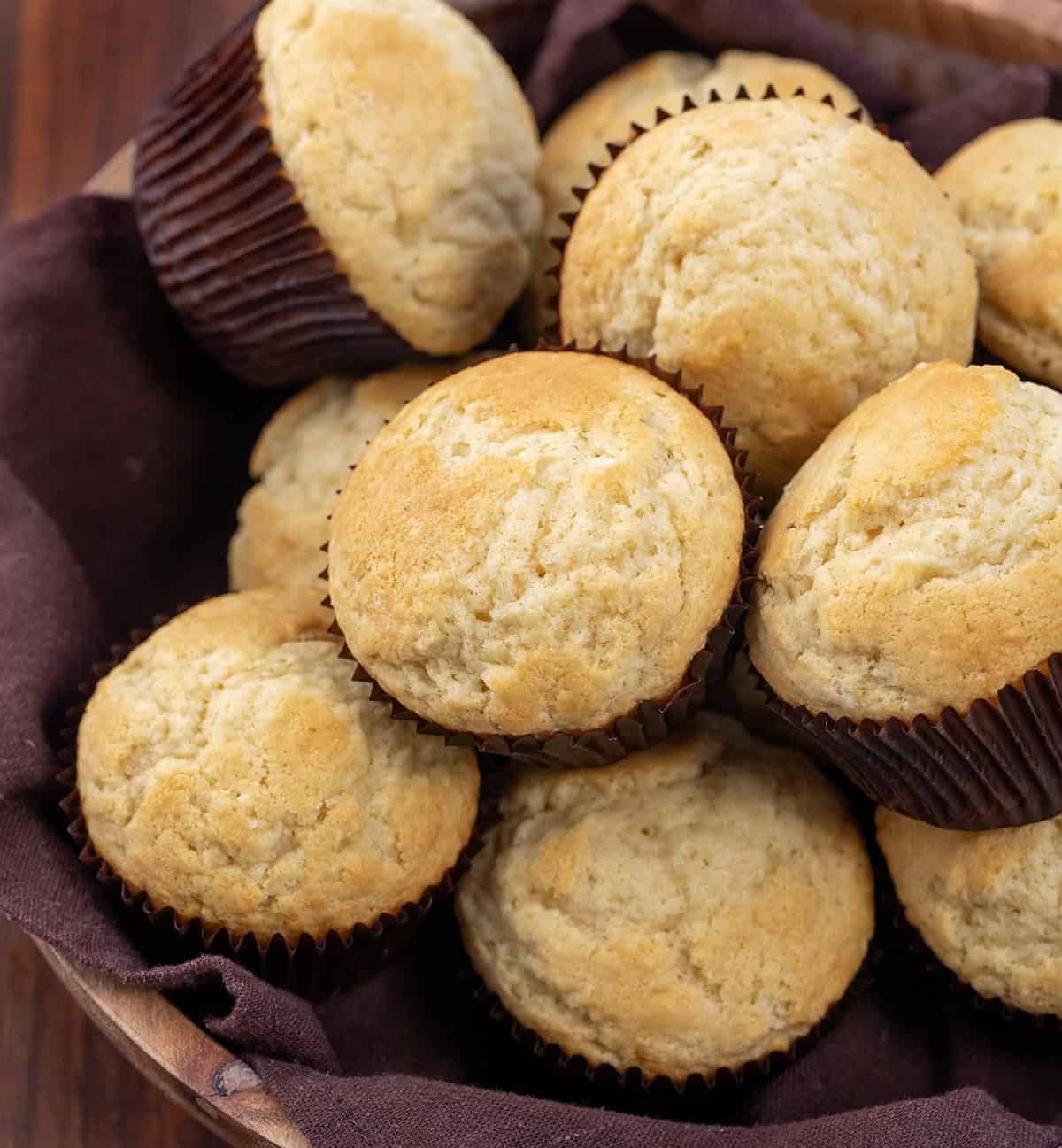 Buttermilk Muffins in a wooden bowl on a wooden table. 