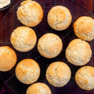 Buttermilk Muffins on a cooling rack on a wooden table.
