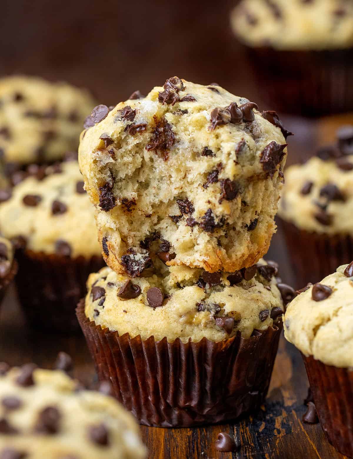 Stacked Banana Chocolate Chip Muffins with the top muffin halved. 