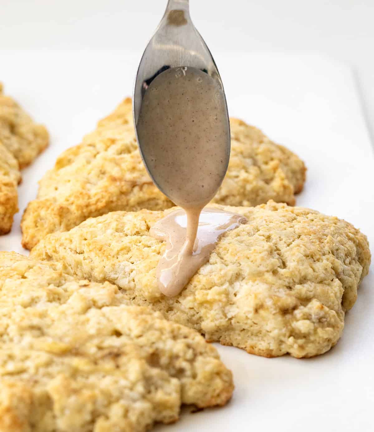 Drizzling maple glaze over Banana Scones.