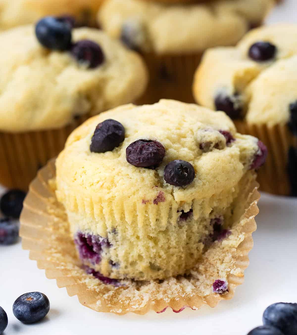 Close up of an unwrapped Blueberry Buttermilk Muffin.