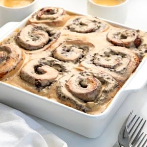 Close up of Chocolate Espresso Rolls on a white table with coffee cups.