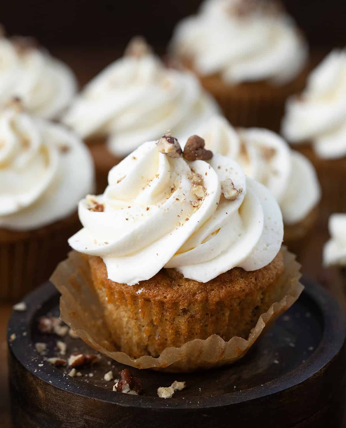 Hummingbird Cupcake with the wrapped pulled away surrounded by more cupcakes.