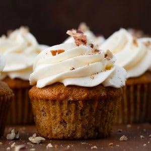 Close up of Hummingbird Cupcakes on a wooden table.