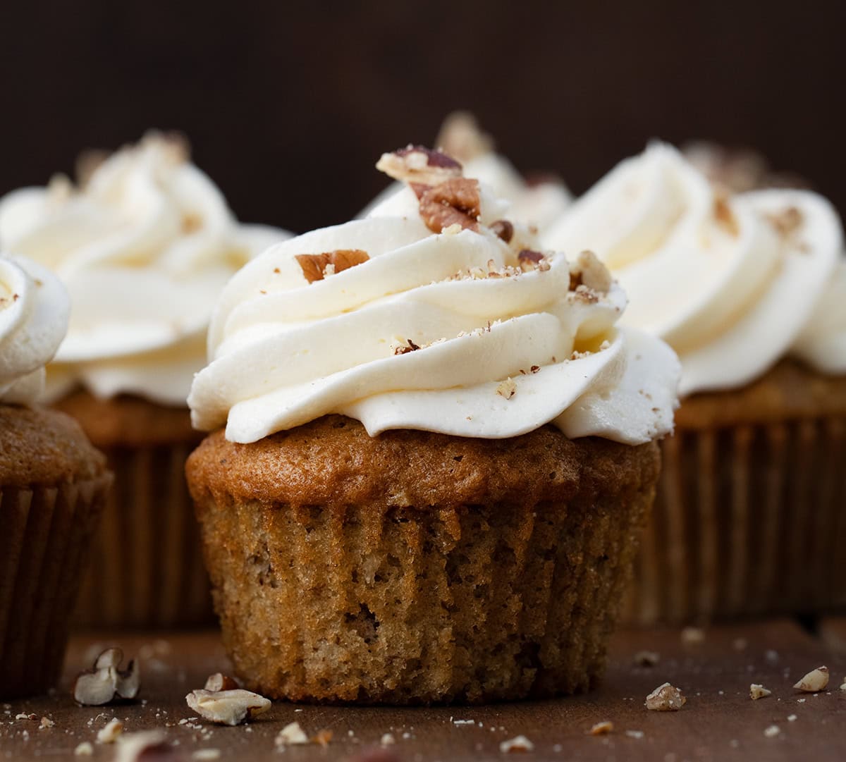 Close up of Hummingbird Cupcakes on a wooden table.