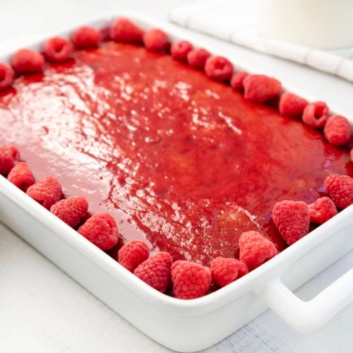 Close up of a Raspberry Sauce Cake on a white table.