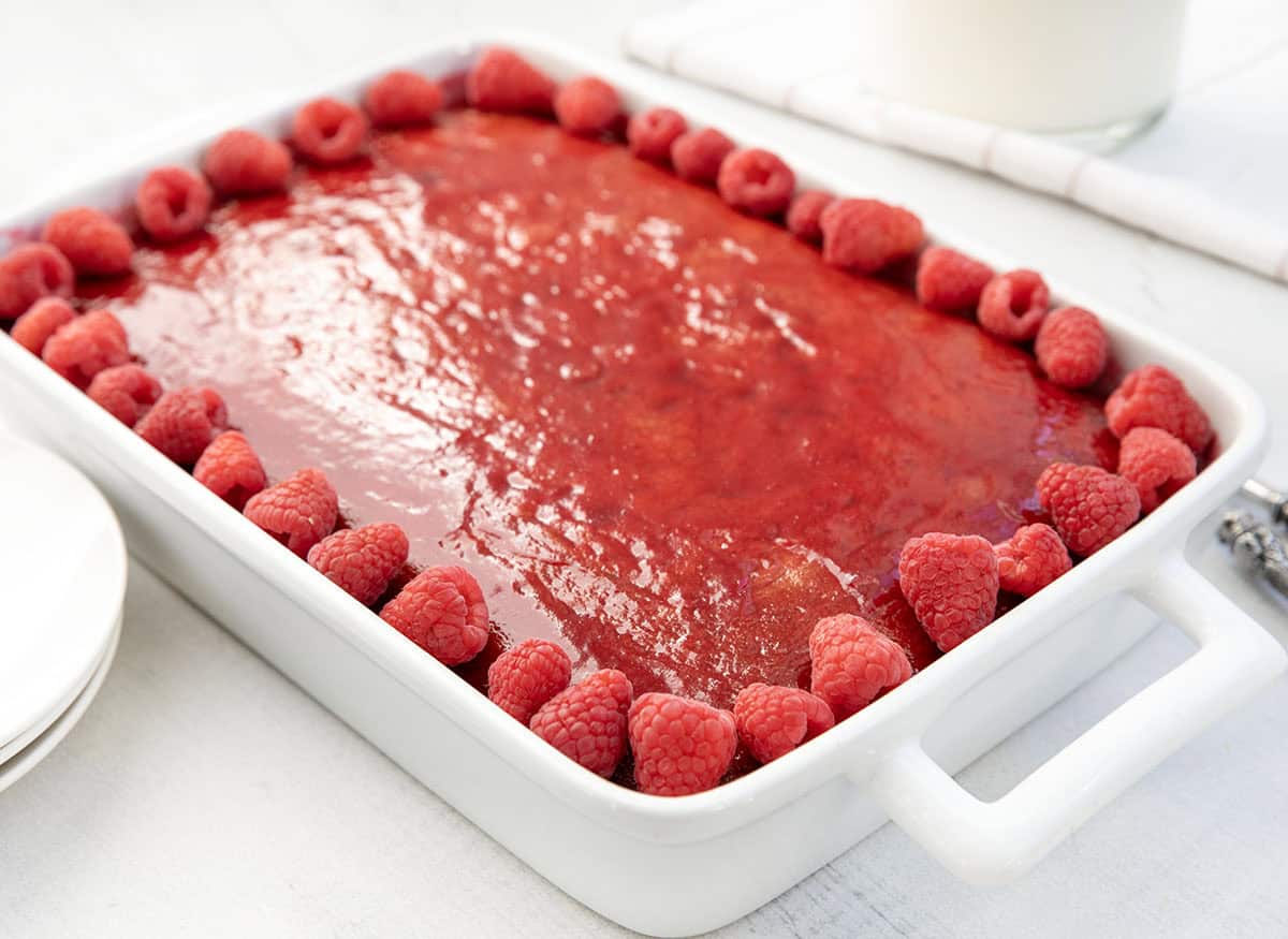 Close up of a Raspberry Sauce Cake on a white table.