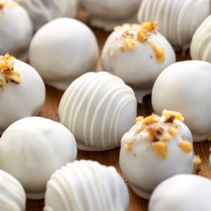 Close up of white chocolate drizzled Carrot Cake Truffles.