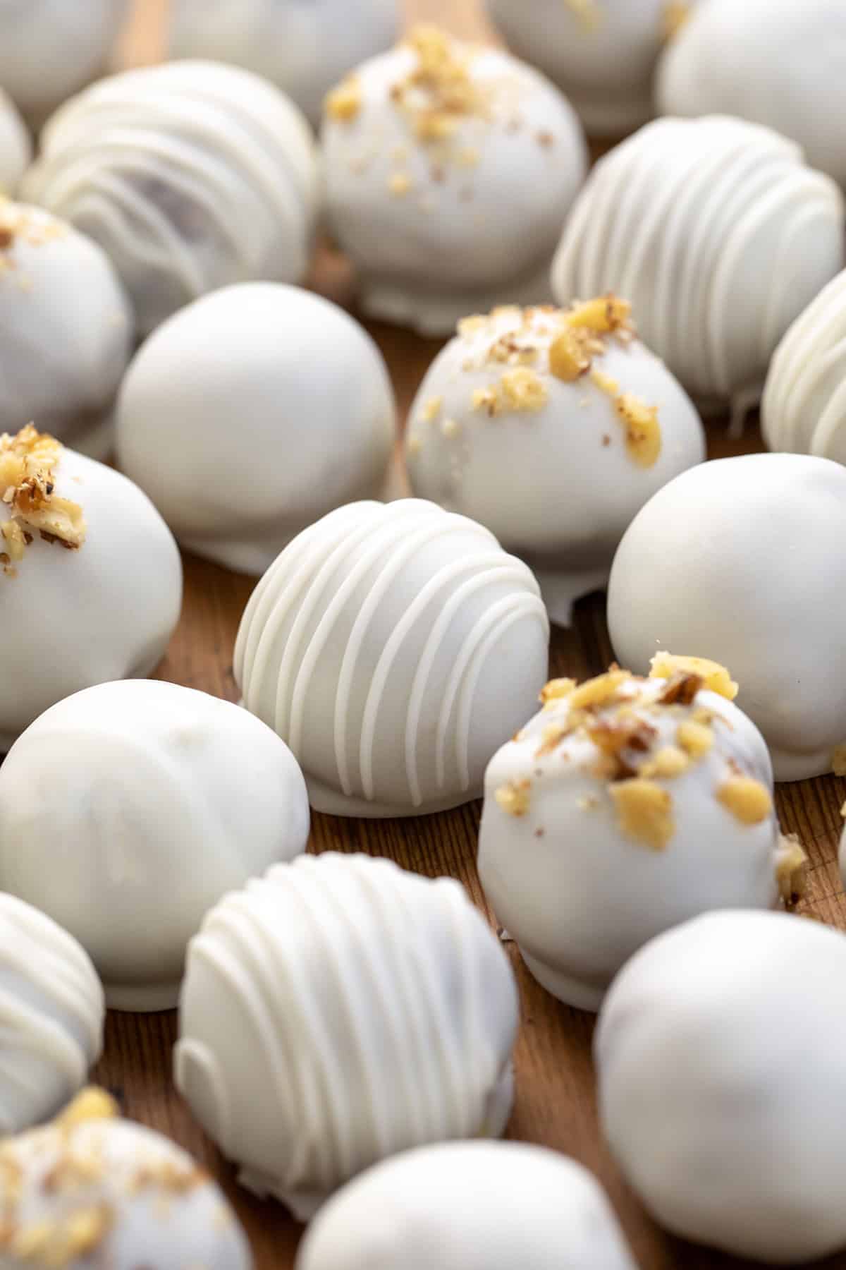 Close up of white chocolate drizzled Carrot Cake Truffles.