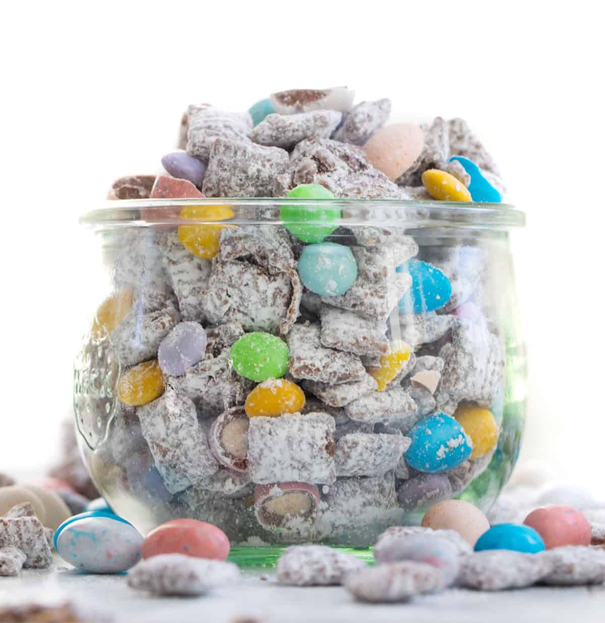 Glass jar filled with Easter Puppy Chow. 