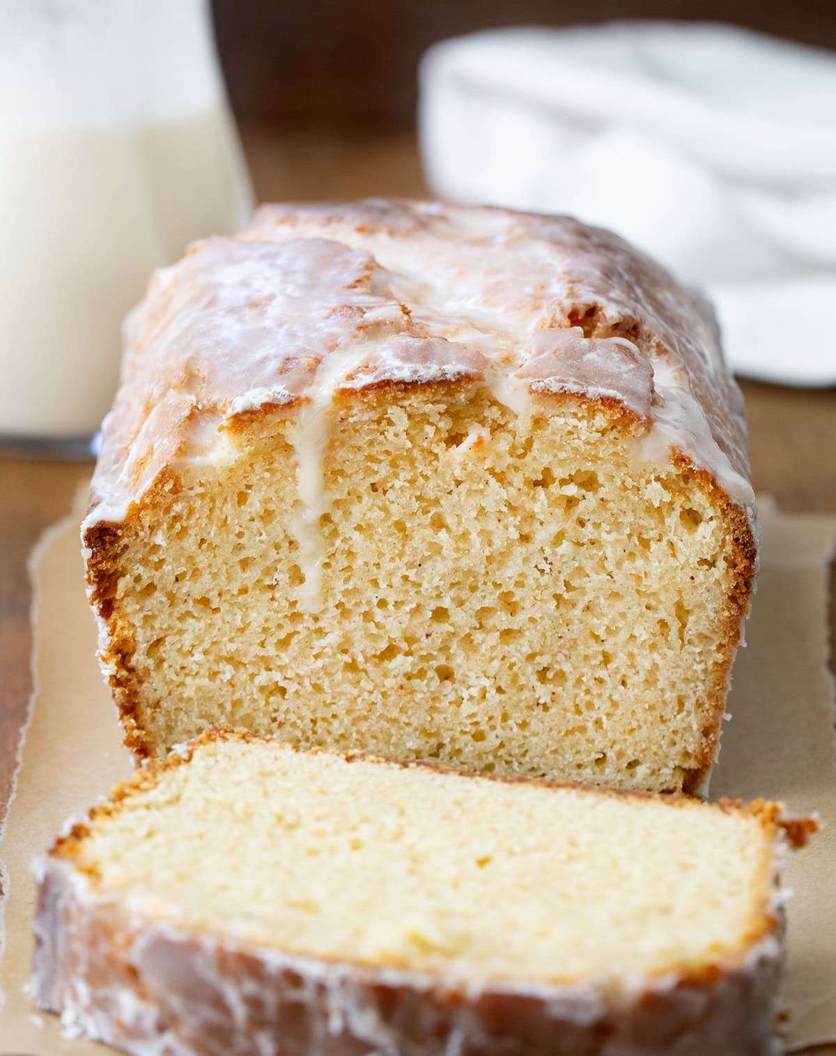 Cut into loaf of Glazed Donut Bread on a wooden table.