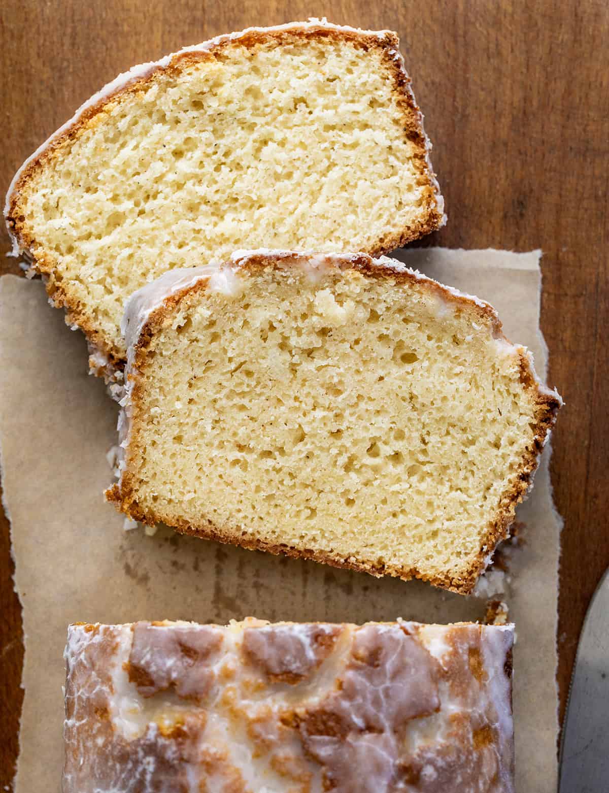 Slices of Glazed Donut Bread laid flat next to loaf from overhead.