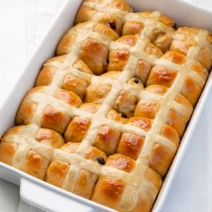 Close up of Hot Cross Buns in a white pan.