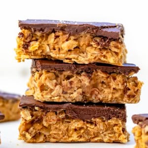 Stack of No-Bake Peanut Butter Oat Bars very close up.