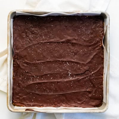 Pan of No-Bake Peanut Butter Oat Bars on a white table.