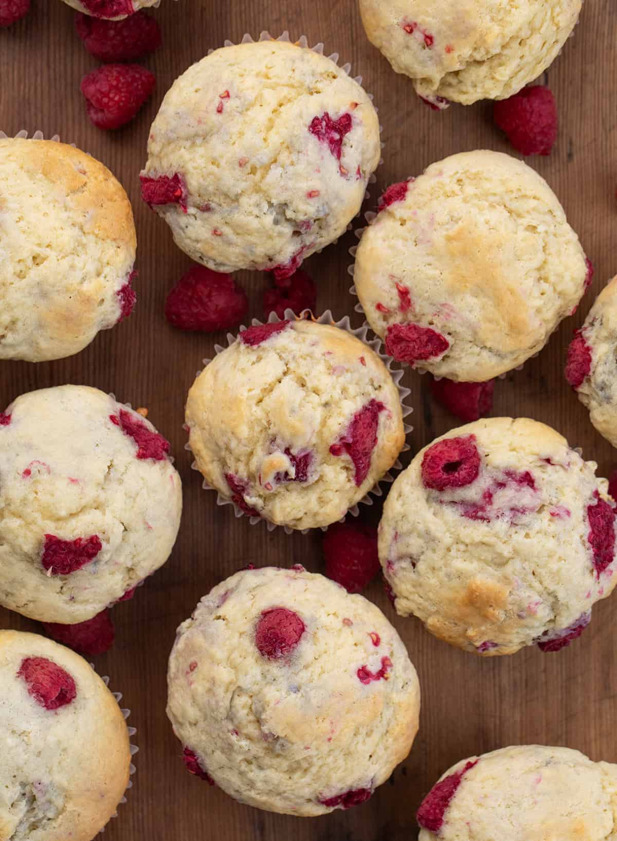 Raspberry Buttermilk Muffins on a wooden table from overhead. 