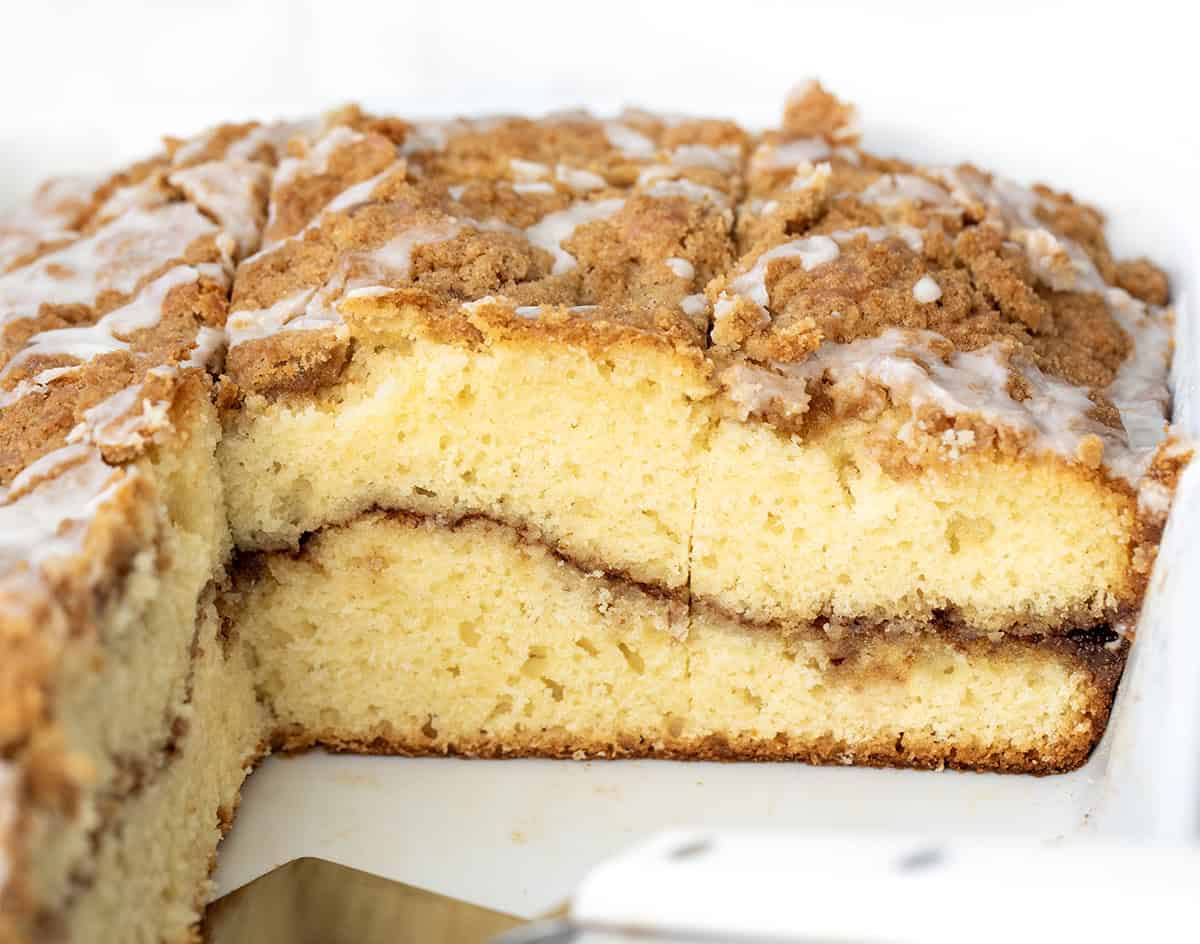 Sour Cream Coffee Cake in the pan with a few pieces missing.