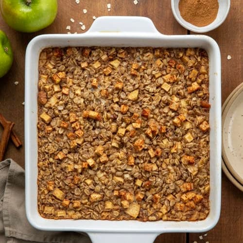 Pan of Apple Cinnamon Baked Oatmeal on a wooden table from overhead.