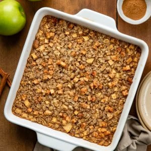 Pan of Apple Cinnamon Baked Oatmeal on a wooden table from overhead.
