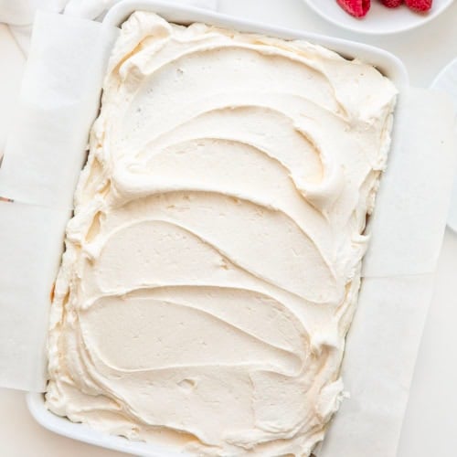 Pan of Best White Sheet Cake on a white table from overhead.