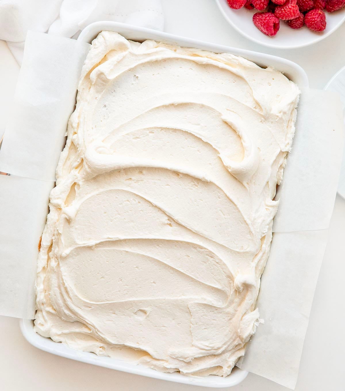 Pan of Best White Sheet Cake on a white table from overhead.