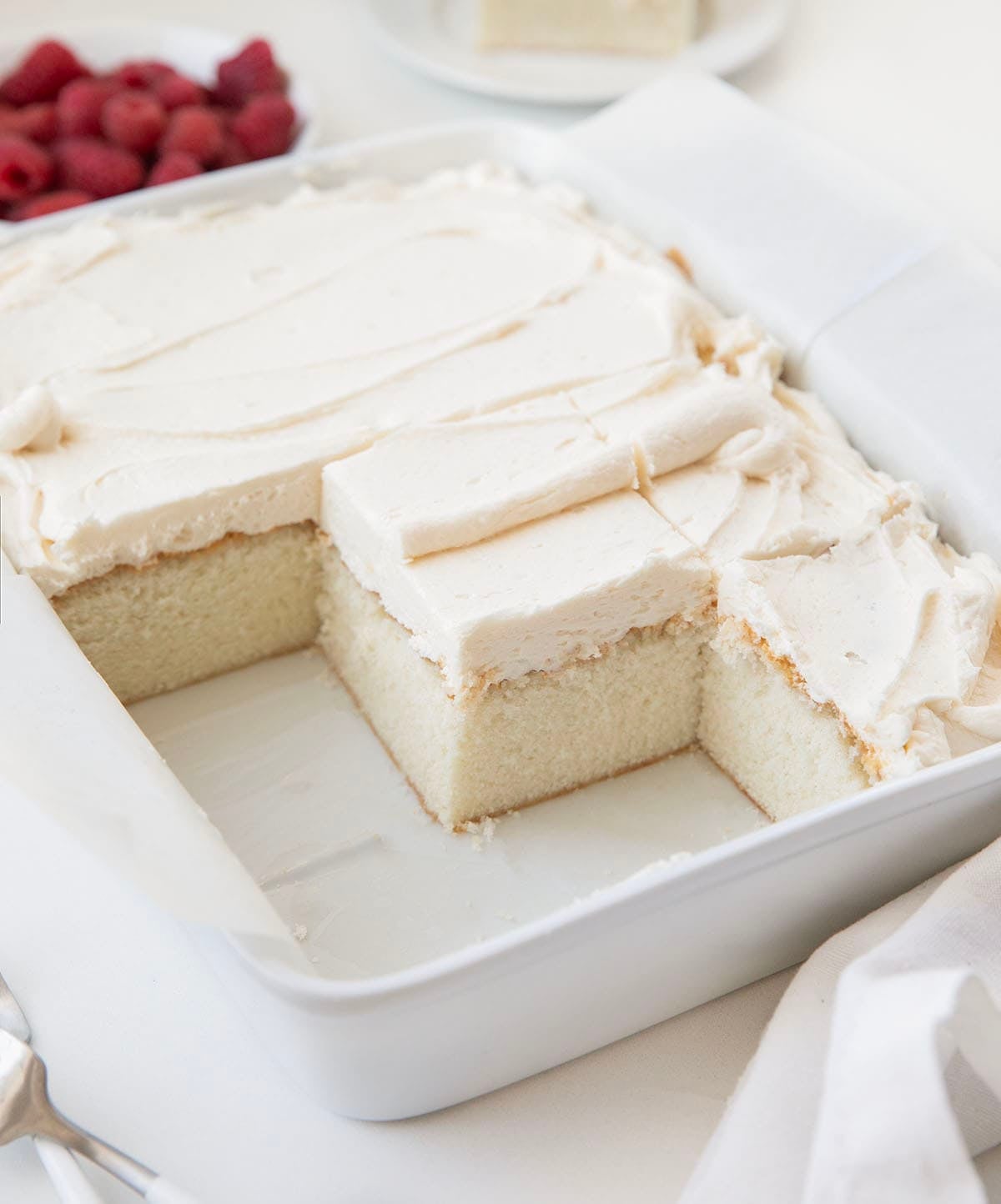 Best White Sheet Cake cut into squares with some pieces removed from the pan.