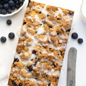 Loaf of Blueberry Crumble Bread on a white table from overhead.