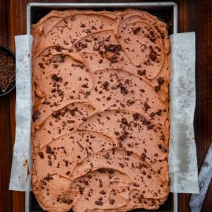 Chocolate Sheet Cake in a 9x13 pan on a wooden table from overhead.